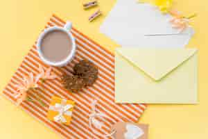 Free photo flowers with envelopes, coffee and cookie