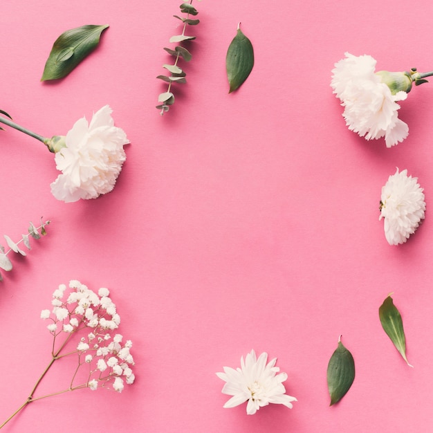 Flowers with leaves scattered on table