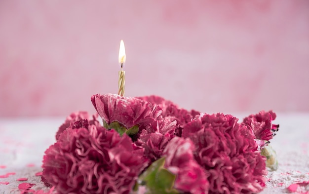 Free photo flowers with lit candle