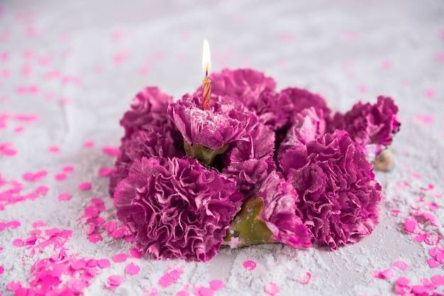 Free photo flowers with lit candle