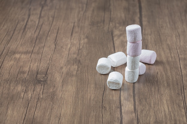 Fluffy marshmallows on a wooden table.