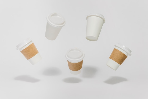 Free photo flying coffee cups