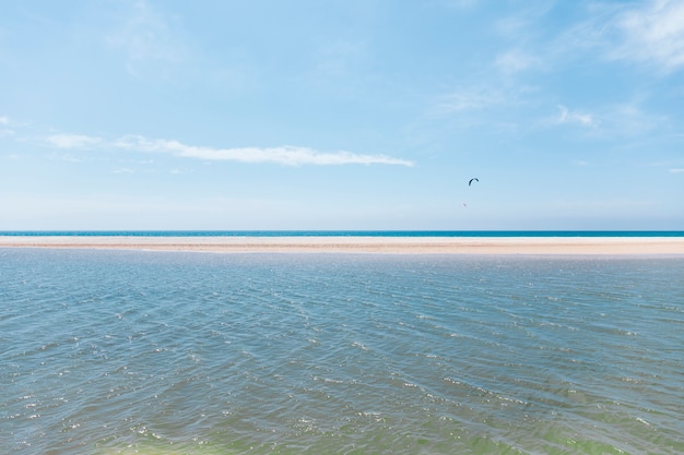 Flying with parachute on exotic seashore