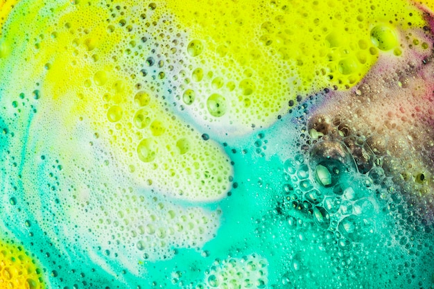 Foam and bubbles form on the surface of bath bomb dissolve in water