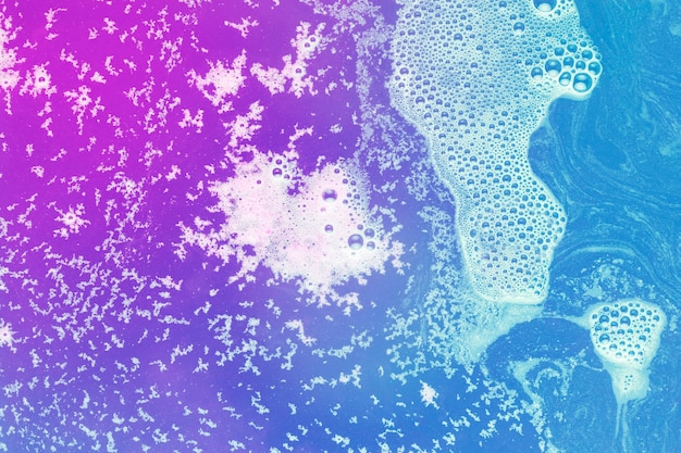 Foam on magenta and blue water