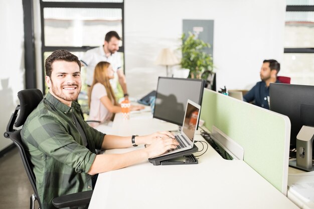 Focus on businessman making eye contact during working at his table in office