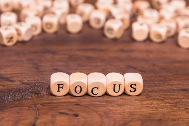 Free Photo focus letters written on wooden cubes over table