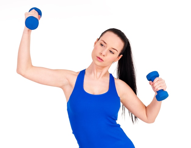 Focus woman exercising with dumbbell