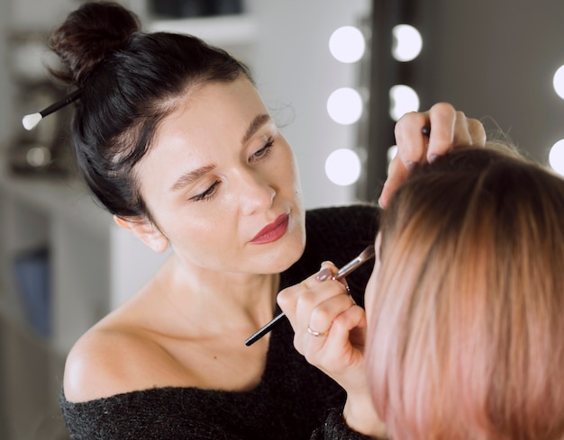 Focused artist doing make up