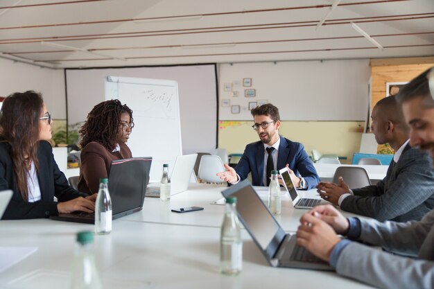 Focused boss communicating with workers