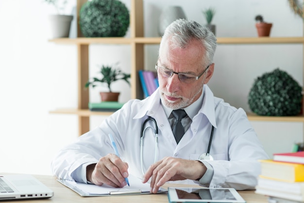 Focused doctor filling papers