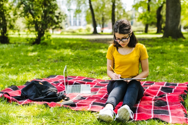 Focused girl studying in the park