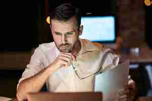 Free photo focused man working late in his home office