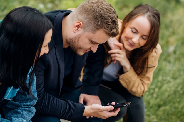 Free Photo focused people sitting and using mobile