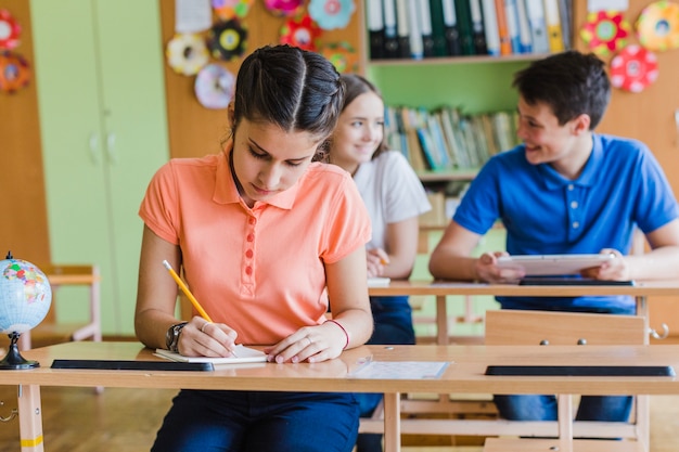 Focused student writing in class