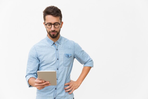 Focused tablet user reading content on screen