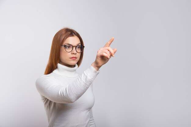 Focused woman pushing virtual button