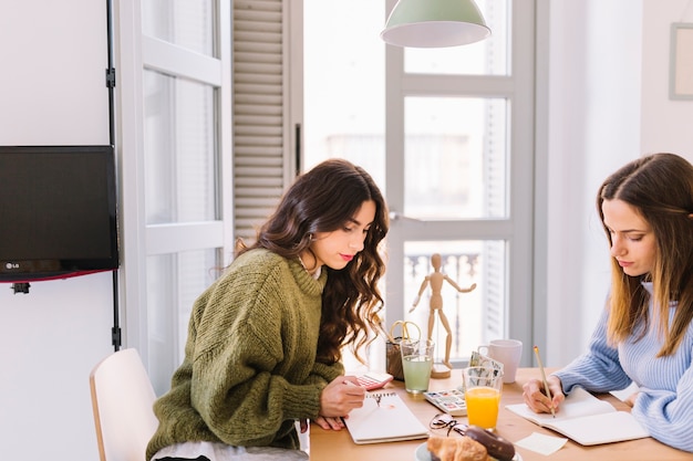 Focused women drawing together