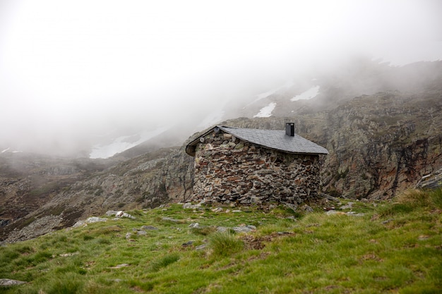 Free Photo foggy landscape and a little house