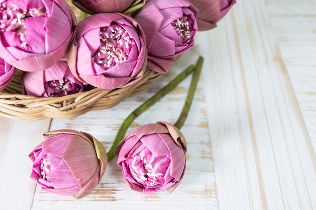 Folded pink lotus on wooden table