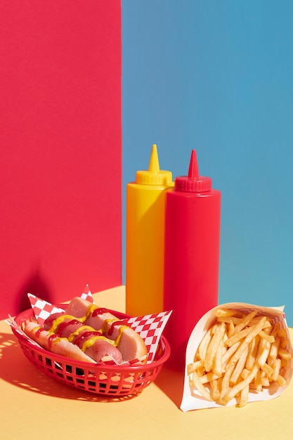 Free Photo food arrangement with hot dog and mustard bottle