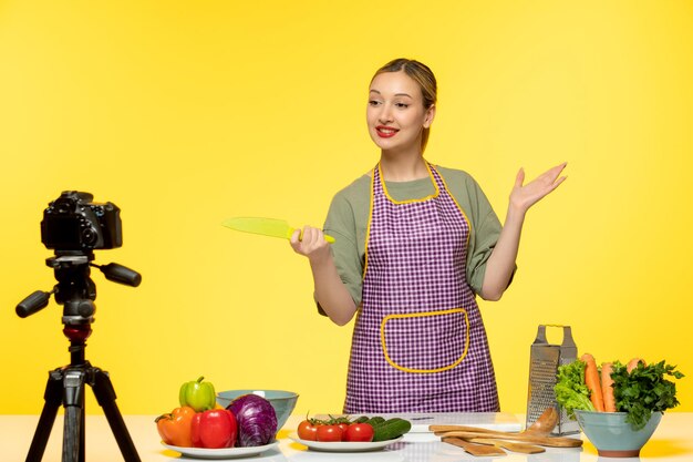 Food blogger adorable healthy chef recording video for social media with the knife