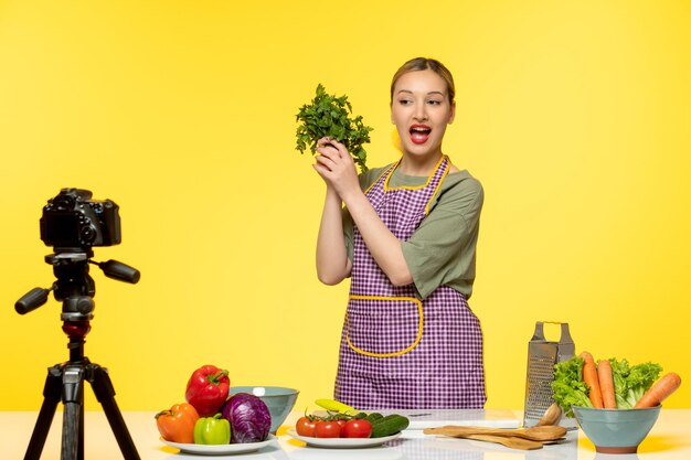 Food blogger pretty cute healthy chef recording video for social media holding parsley