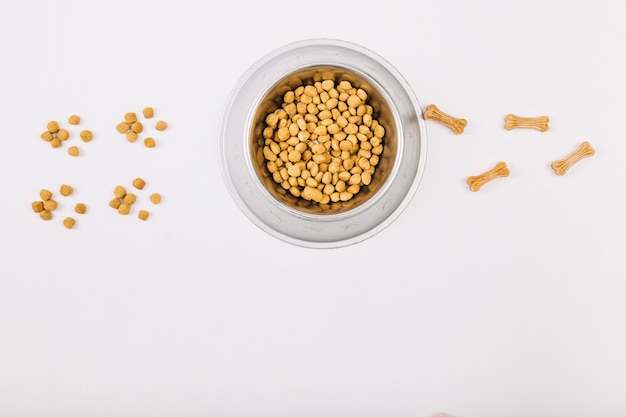 Food and chewing bones near bowl