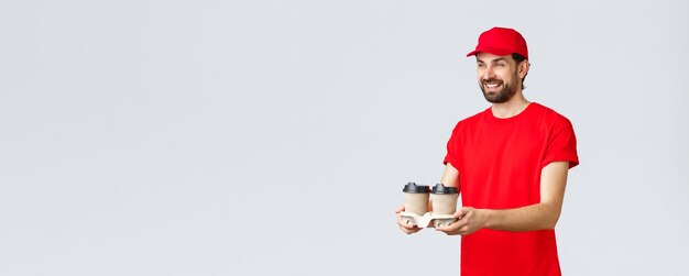 Food delivery quarantine stay home and order online concept friendly courier in red uniform cap and