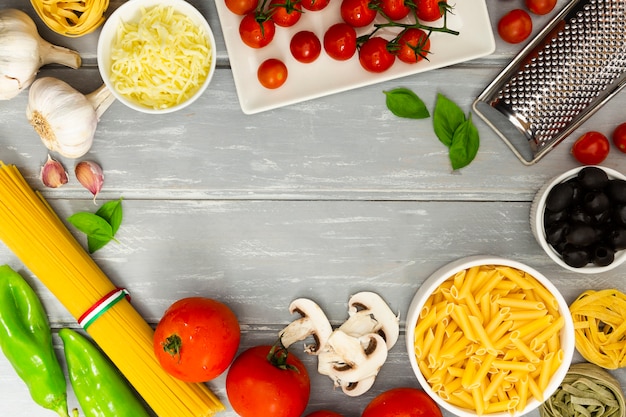 Food frame with pasta and tomatoes