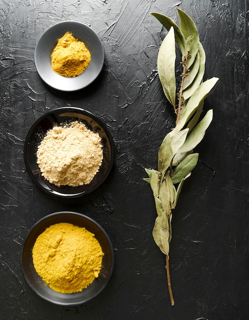 Free photo food powder in bowls and ingredient leaves