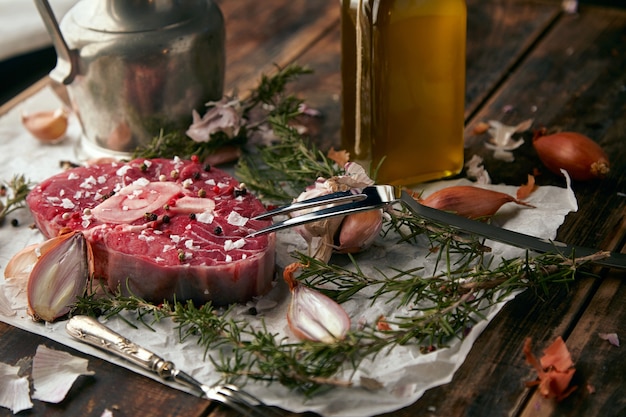 Food set, onions, romero, meat steak, salt, pepper, garlic, olive oil,fork