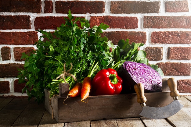 Free photo food vegetable colorful background. tasty fresh vegetables in wooden box on wooden table. kitchen background. copy space.