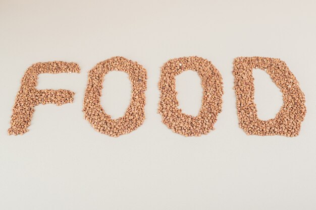 food Writing on a concrete with brown beans.