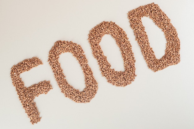 Free photo food writing with green lentils on a white.