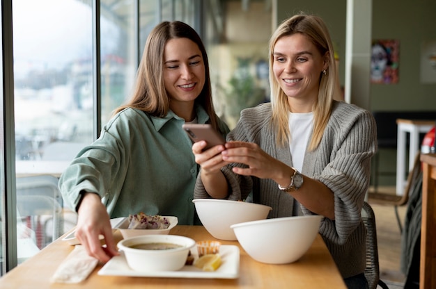 Foodie taking photo of a bowl with soup