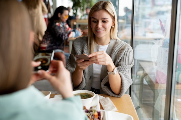 Foodie taking photo of a bowl with soup