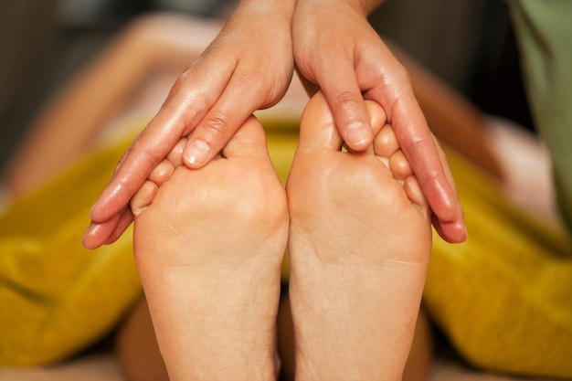 Foot massage for a woman in a spa 