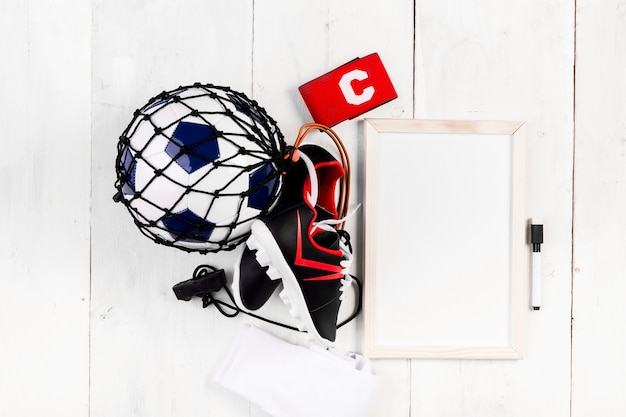 Free photo football composition with whiteboard and ball in net