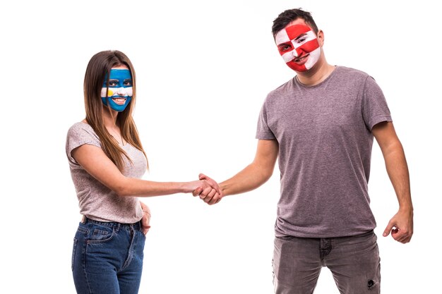 Football fans of Argentina and Croatia national teams with painted face shake hands