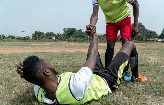 Football player sitting on field