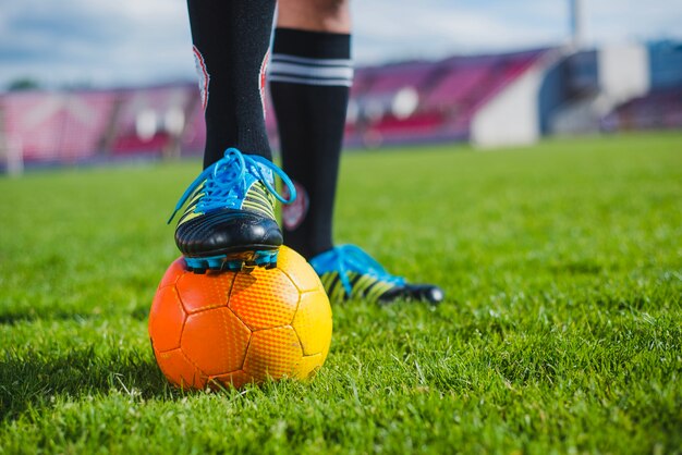 Football player with foot on ball