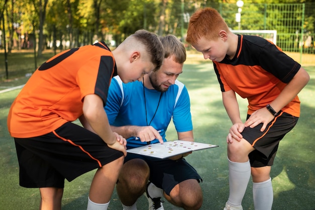 Football trainer teaching his pupils