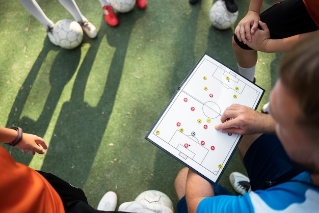 Free photo football trainer teaching his pupils