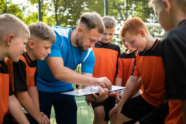 Football trainer teaching his pupils