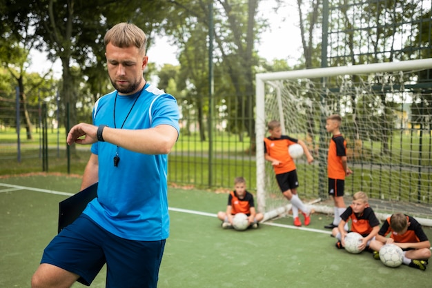 Free photo football trainer teaching his pupils