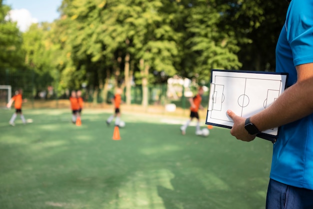 Free photo football trainer teaching his pupils