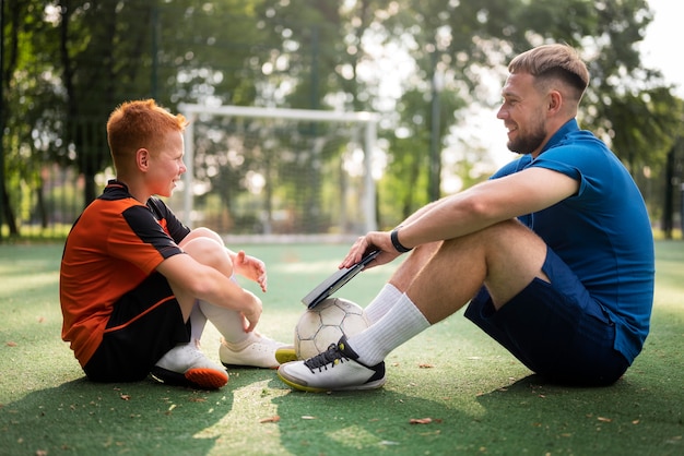 Football trainer teaching his pupils