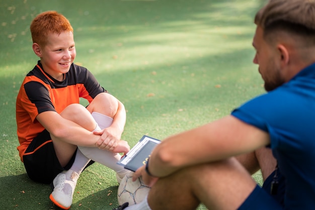 Football trainer teaching his pupils