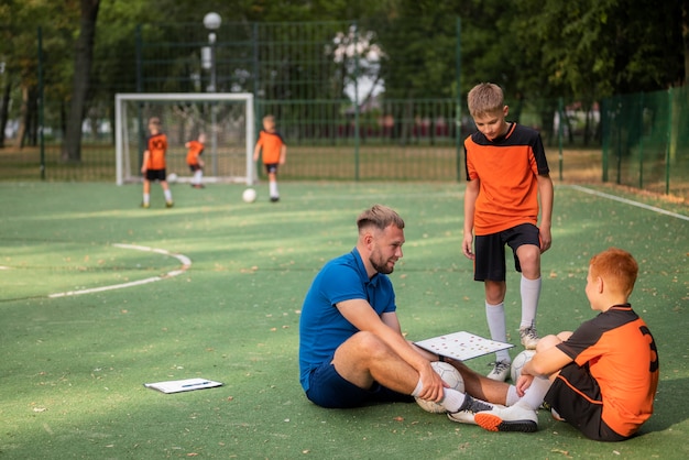 Football trainer teaching his pupils